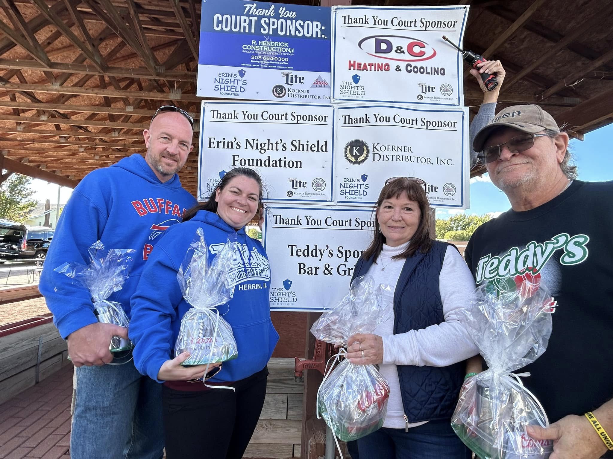 Bocce Fun Day team with sponsor wall
